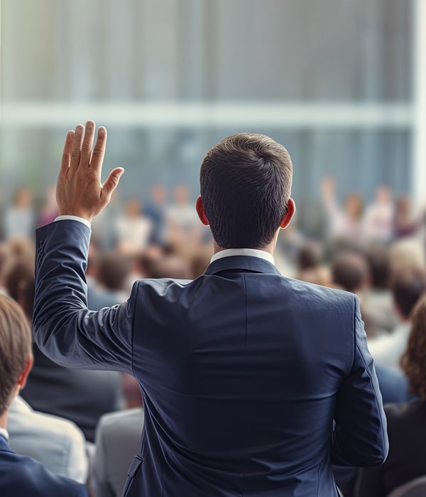 A man raising hand in a conference